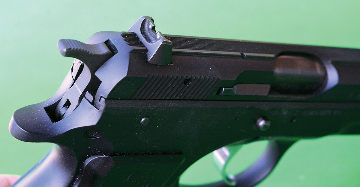 The rear sight is dovetailed in place and features two dots.